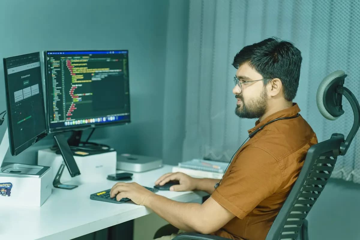 Software engineer writing code at a desk in a Bengaluru fintech office