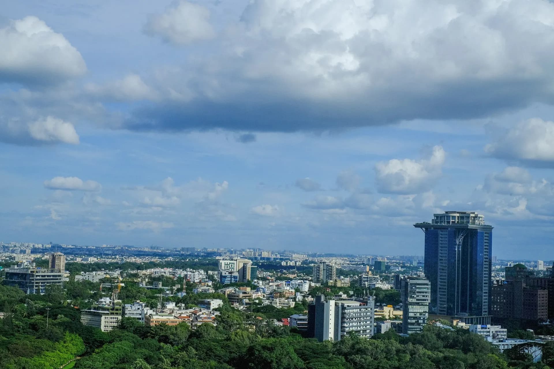 Bengaluru skyline with office towers and green tree cover