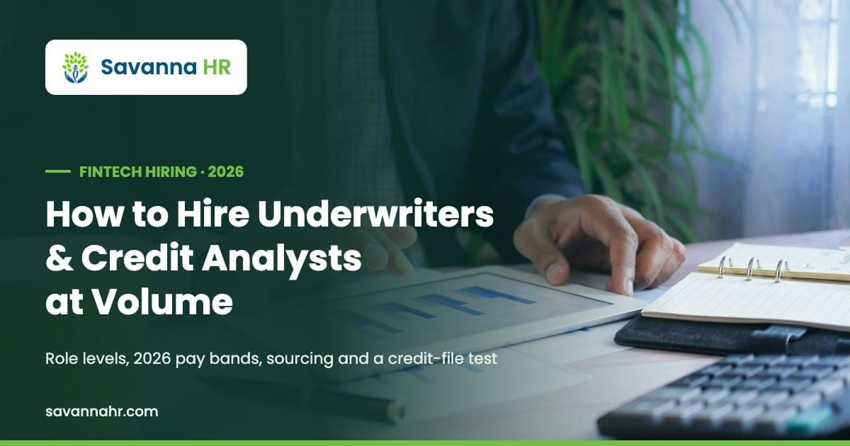 Credit analyst reviewing financial charts on a tablet with a calculator and documents
