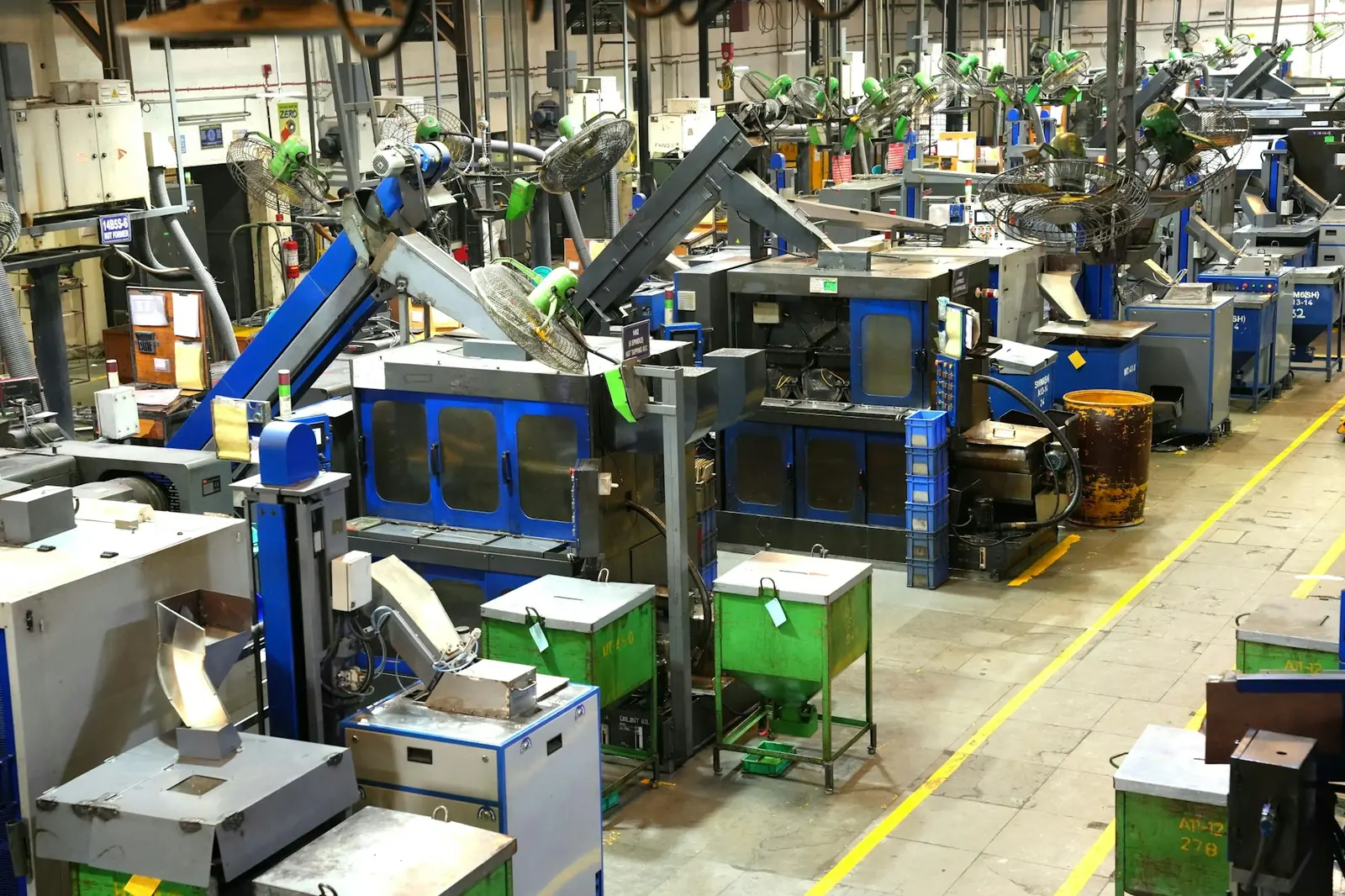 A busy machining shop floor with rows of production machines
